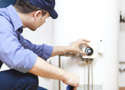 Service technician turns a button on the wall